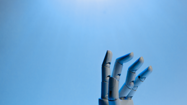 A robot hand reaching out from below, symbolizing the emergence of AI and the introduction of the future of ai